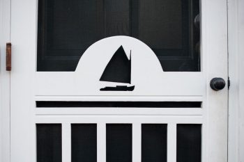 White door with a sailboat decoration
